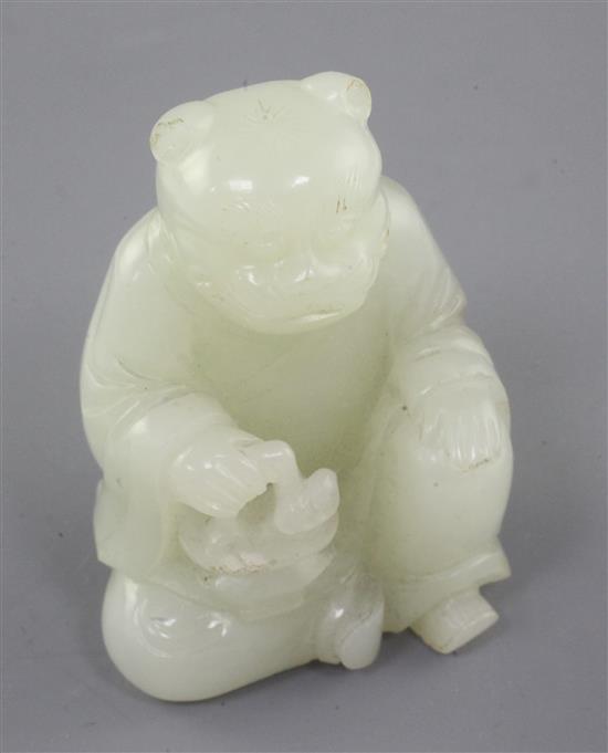 A Chinese pale celadon jade tiger-headed figure of a man, 18th / 19th century., height 5.2cm, tiny chips